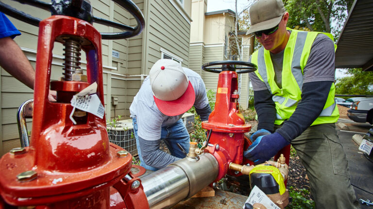 Men installing a backflow preventer. 