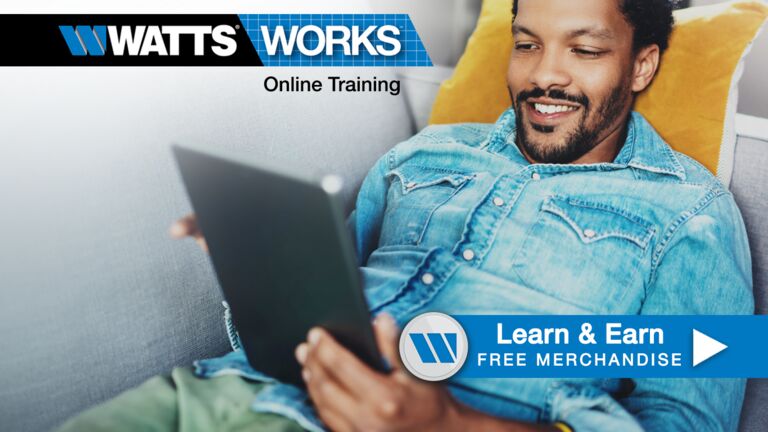 Man sitting on a couch working on an online module