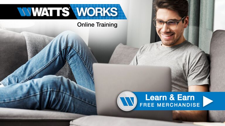 Man lying on a couch working on a computer